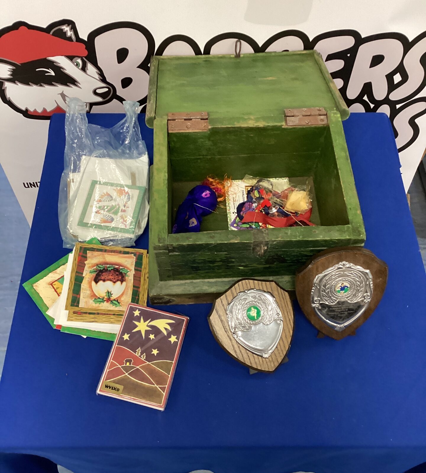 Vintage trophy box filled with Christmas cards and trophies.