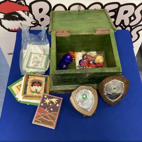 Vintage trophy box filled with Christmas cards and trophies.