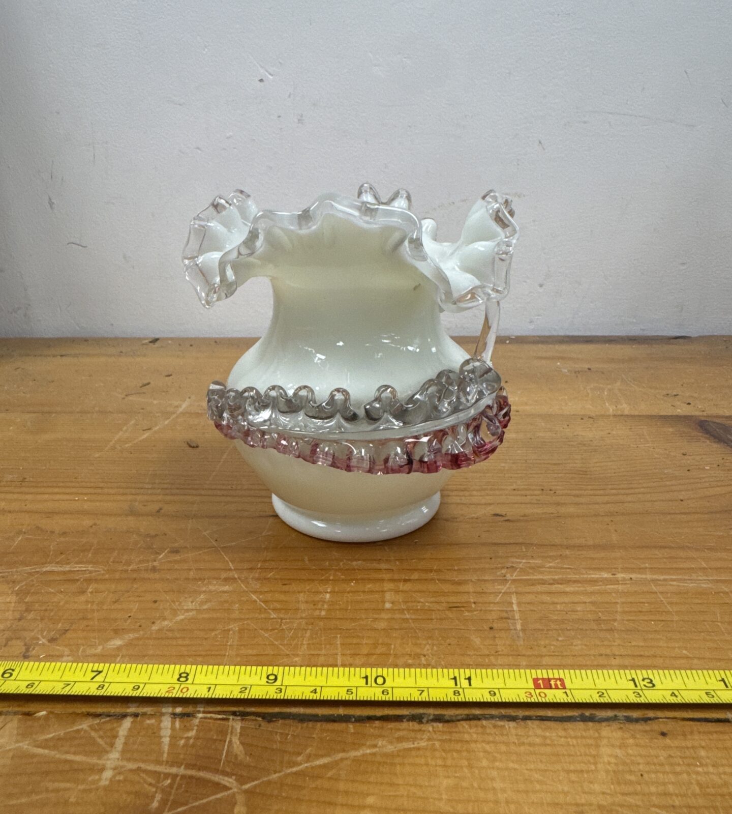 Vintage green uranium glass vase with scalloped rim.