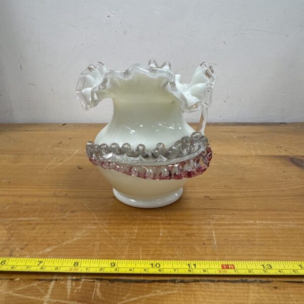 Vintage green uranium glass vase with scalloped rim.