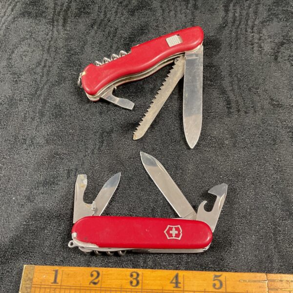 Vintage Victorinox Swiss Army Knife with red handle and tools.