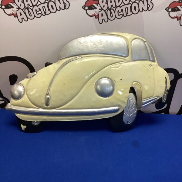 Vintage tin VW Beetle wall hanging for retro decor.