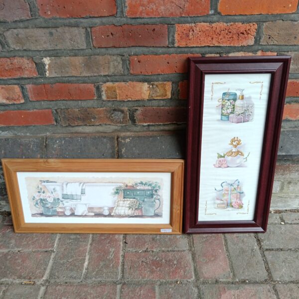 Pair of vintage washroom prints in ornate frames.