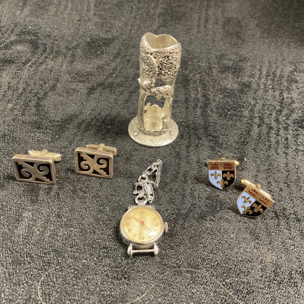 Vintage watch and silver cufflinks in a collectible lot.