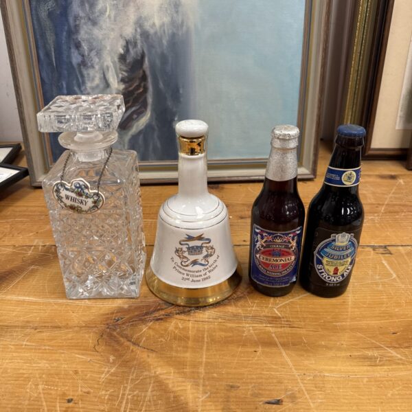 Vintage whisky decanter, Bells bell, and sealed ale bottles set.