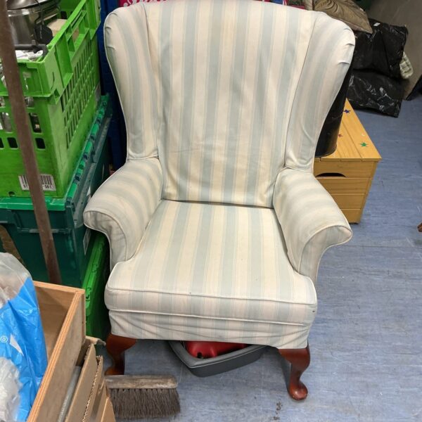 Vintage patterned wingback armchair, classic mid-century style.