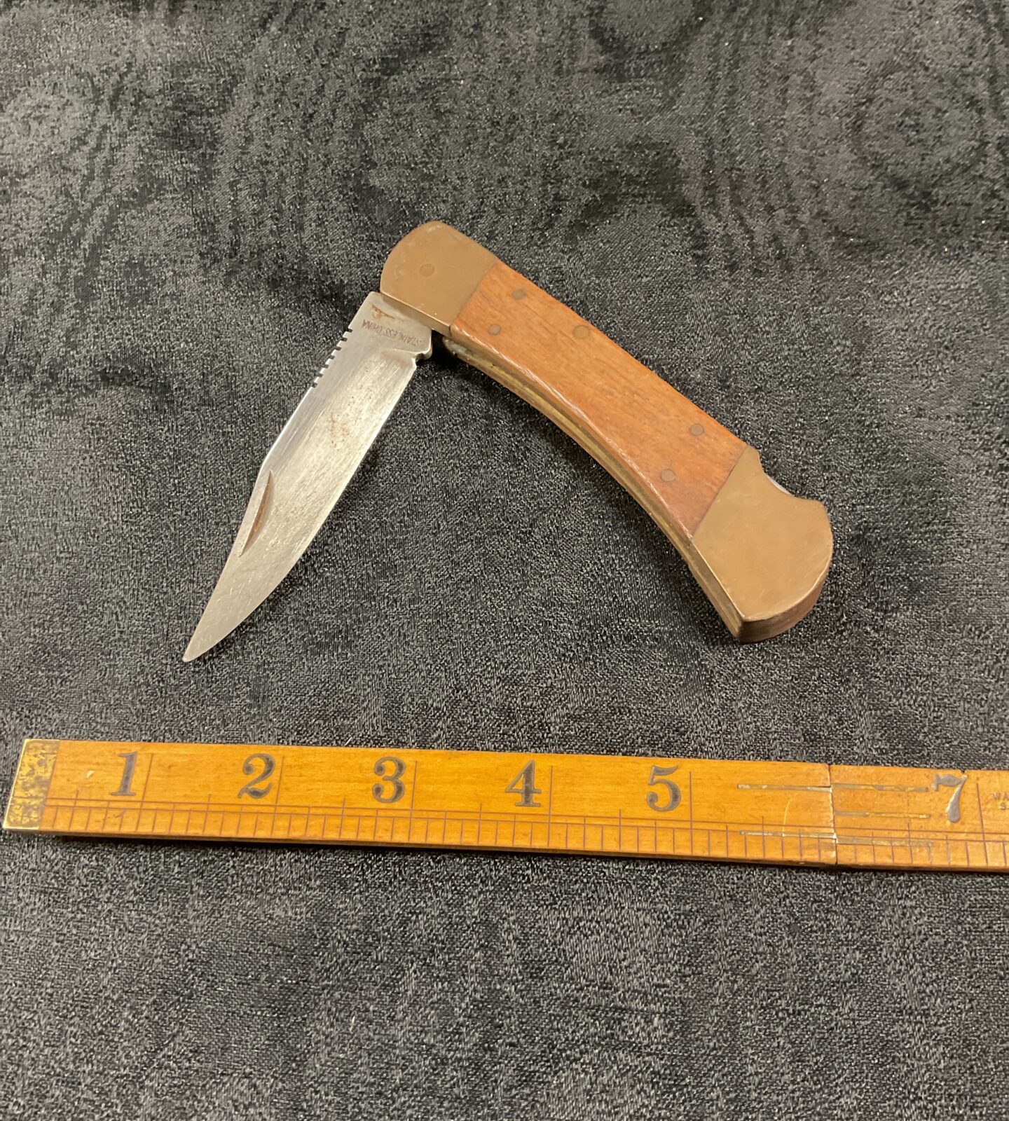 Vintage wood handled pocket knife with folding blade.