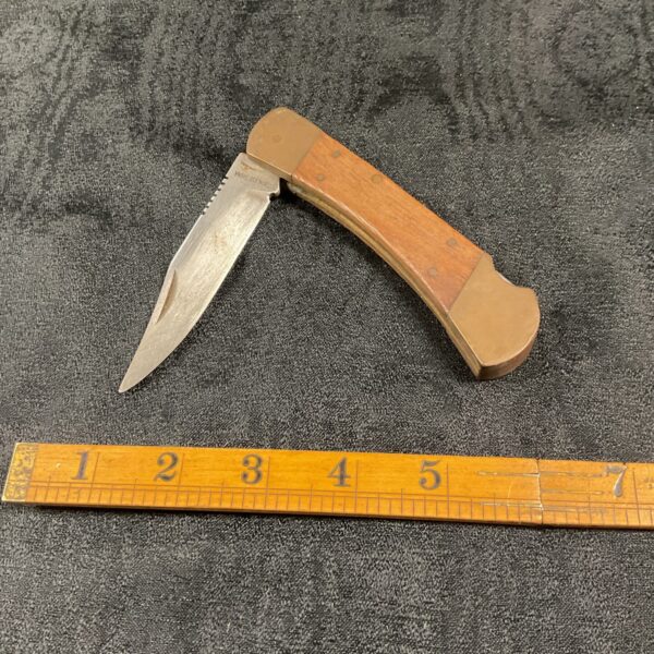 Vintage wood handled pocket knife with folding blade.