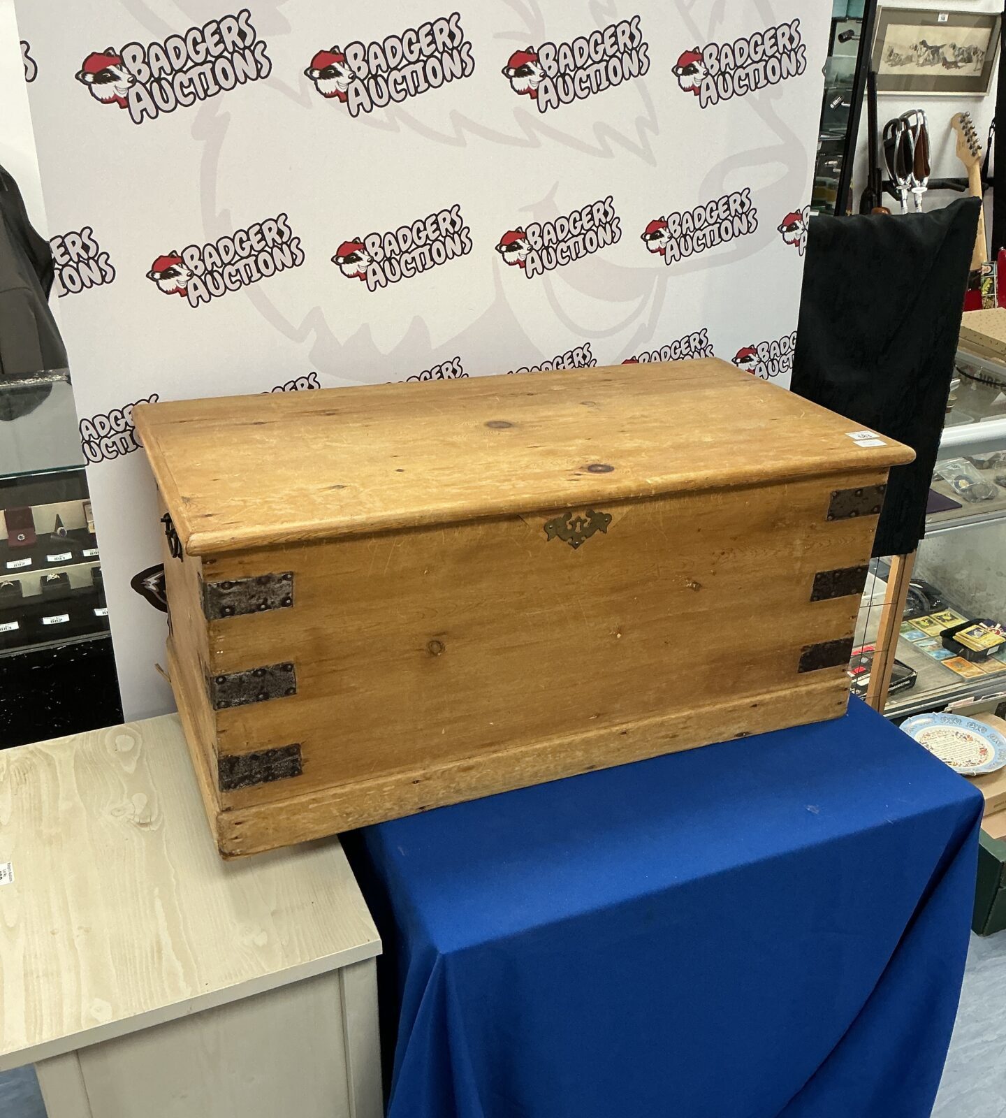 Front view of a vintage wooden storage chest with rustic details.
