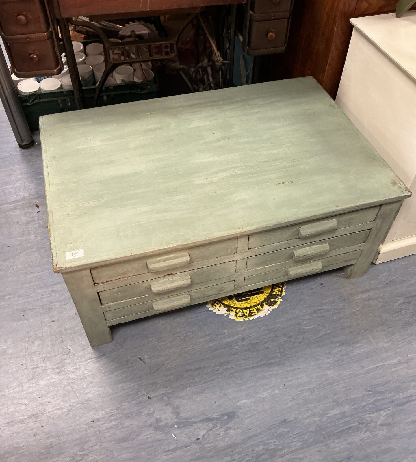 Vintage wooden drawer unit with multiple drawers for storage.