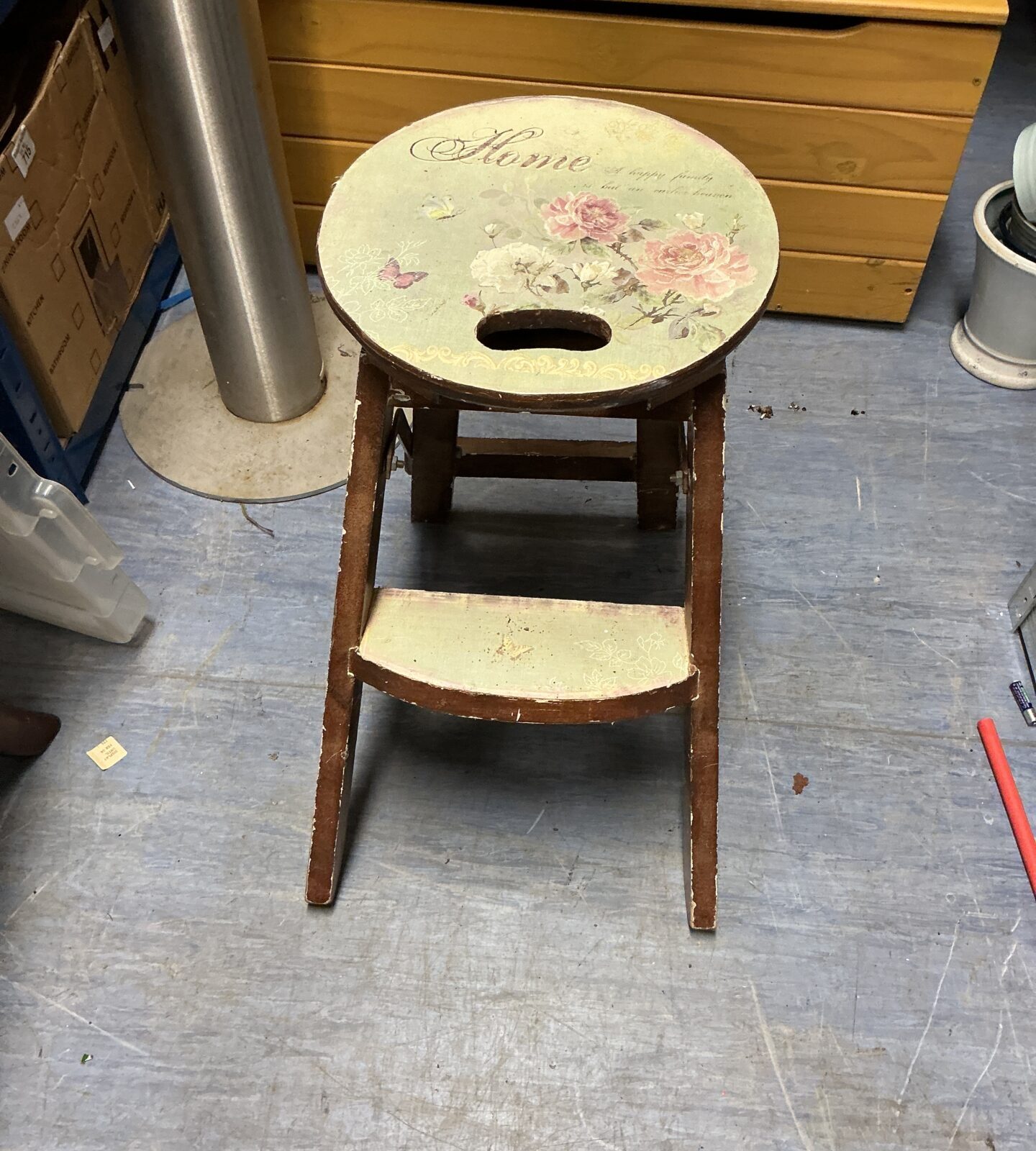 Vintage wooden step stool with floral design for kitchen use.