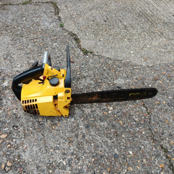 Vintage yellow petrol chainsaw for garden and DIY tasks.
