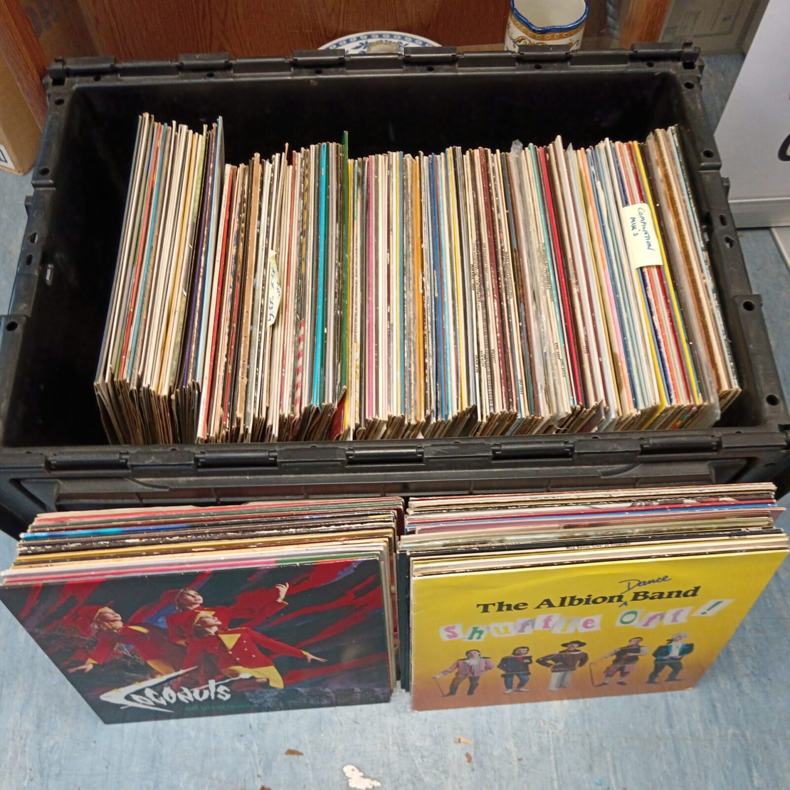 Large crate filled with a diverse vinyl record collection.