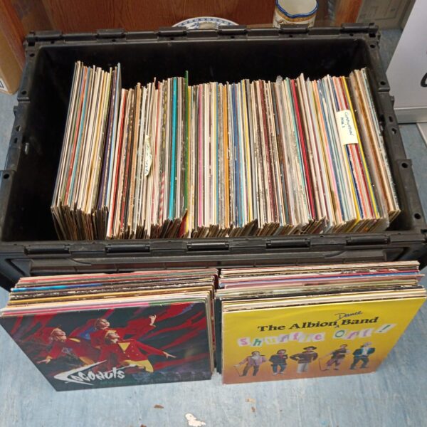 Large crate filled with a diverse vinyl record collection.