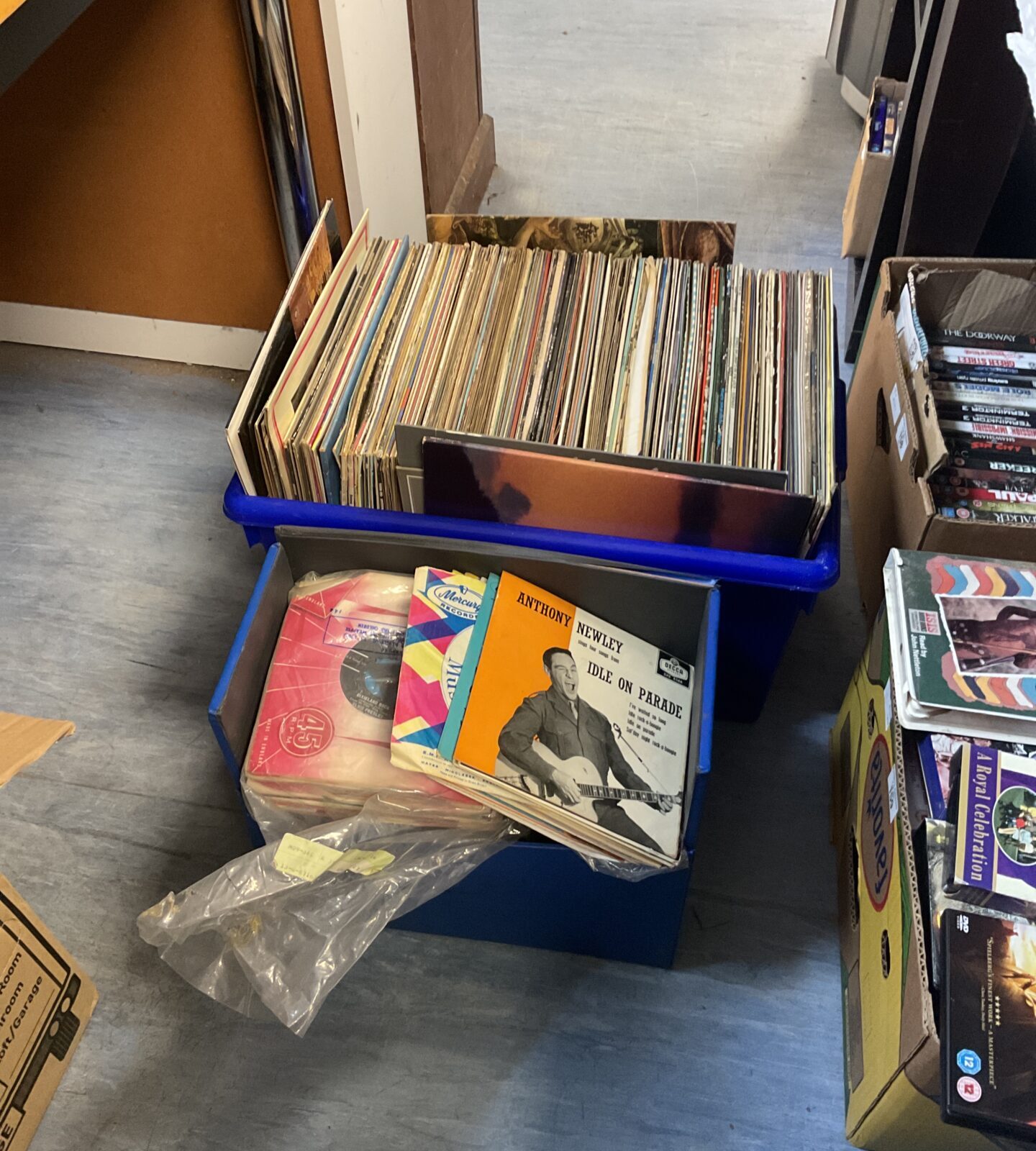 Blue case filled with a diverse lot of vinyl records.