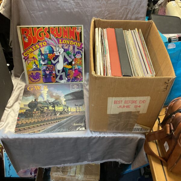Box of mixed vinyl records for music collectors.