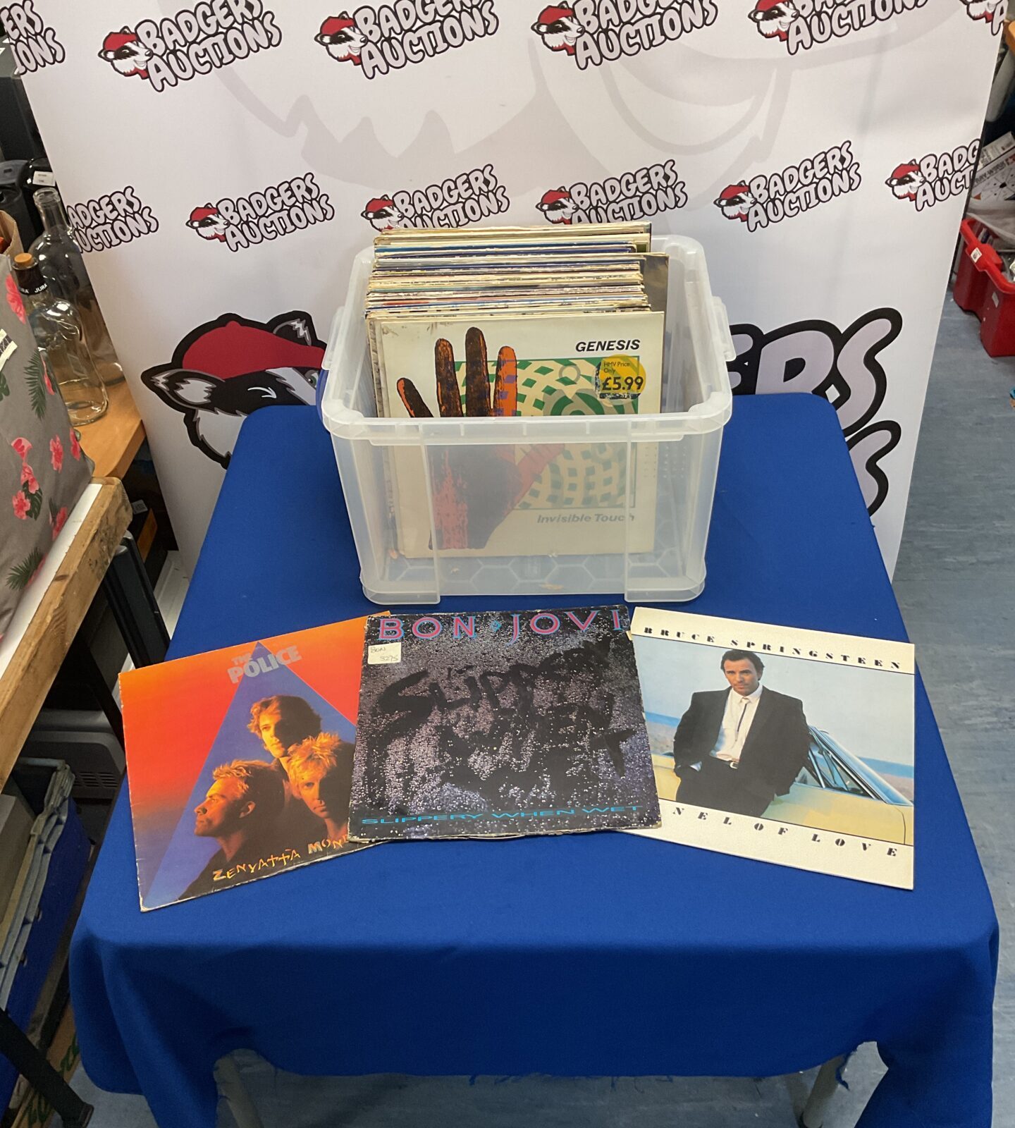 Vintage vinyl records collection including The Police, Bon Jovi, and Bruce Springsteen.