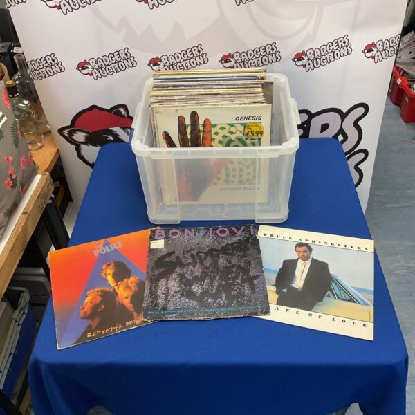 Vintage vinyl records collection including The Police, Bon Jovi, and Bruce Springsteen.