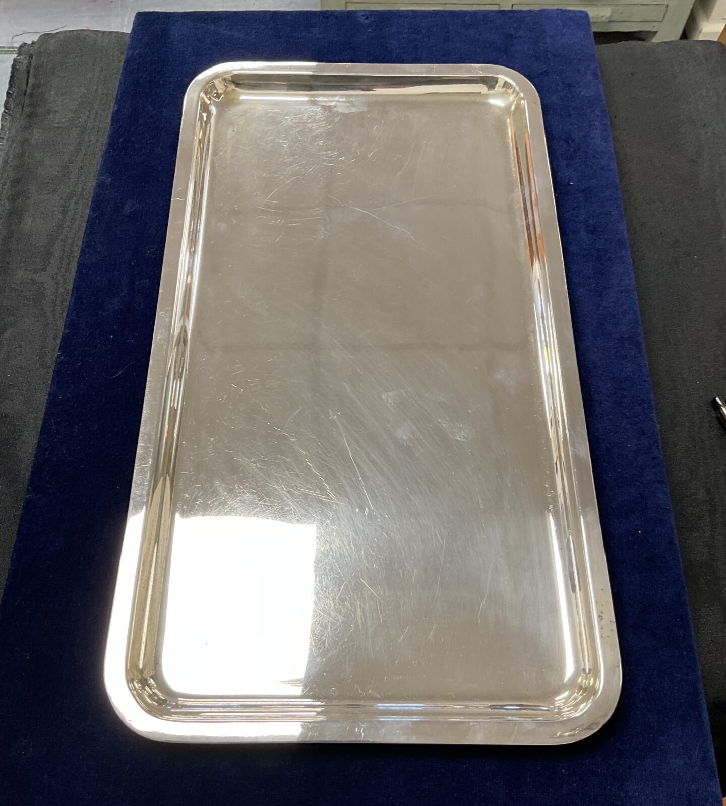 Vintage Walker and Hall silver plated salver on blue background.