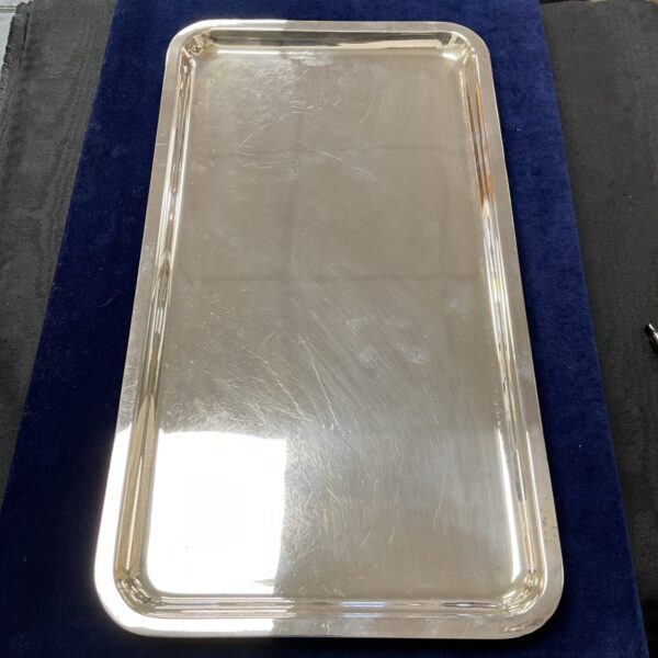 Vintage Walker and Hall silver plated salver on blue background.