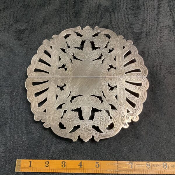 Intricate antique Wallace silver trivet with detailed openwork design.