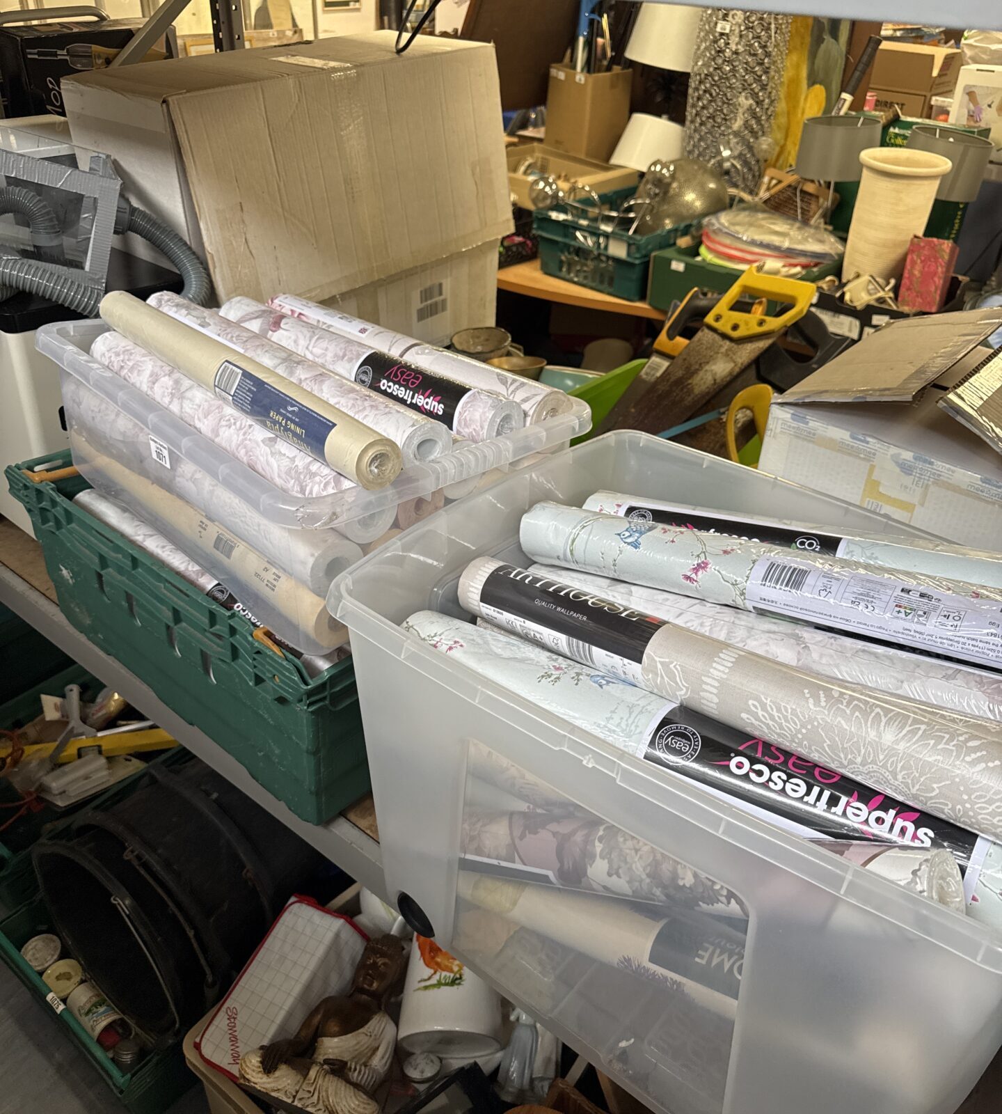 Assorted wallpaper rolls in boxes, ideal for home decor projects.