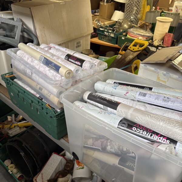 Assorted wallpaper rolls in boxes, ideal for home decor projects.