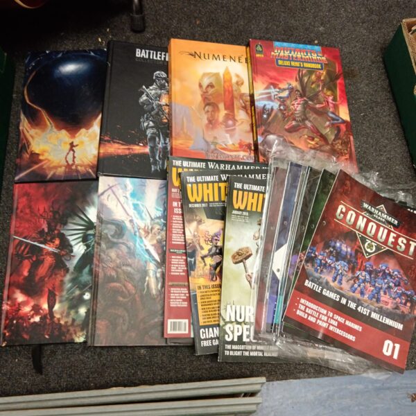 Lot of Warhammer 40k rulebooks and strategy guides for tabletop gaming.