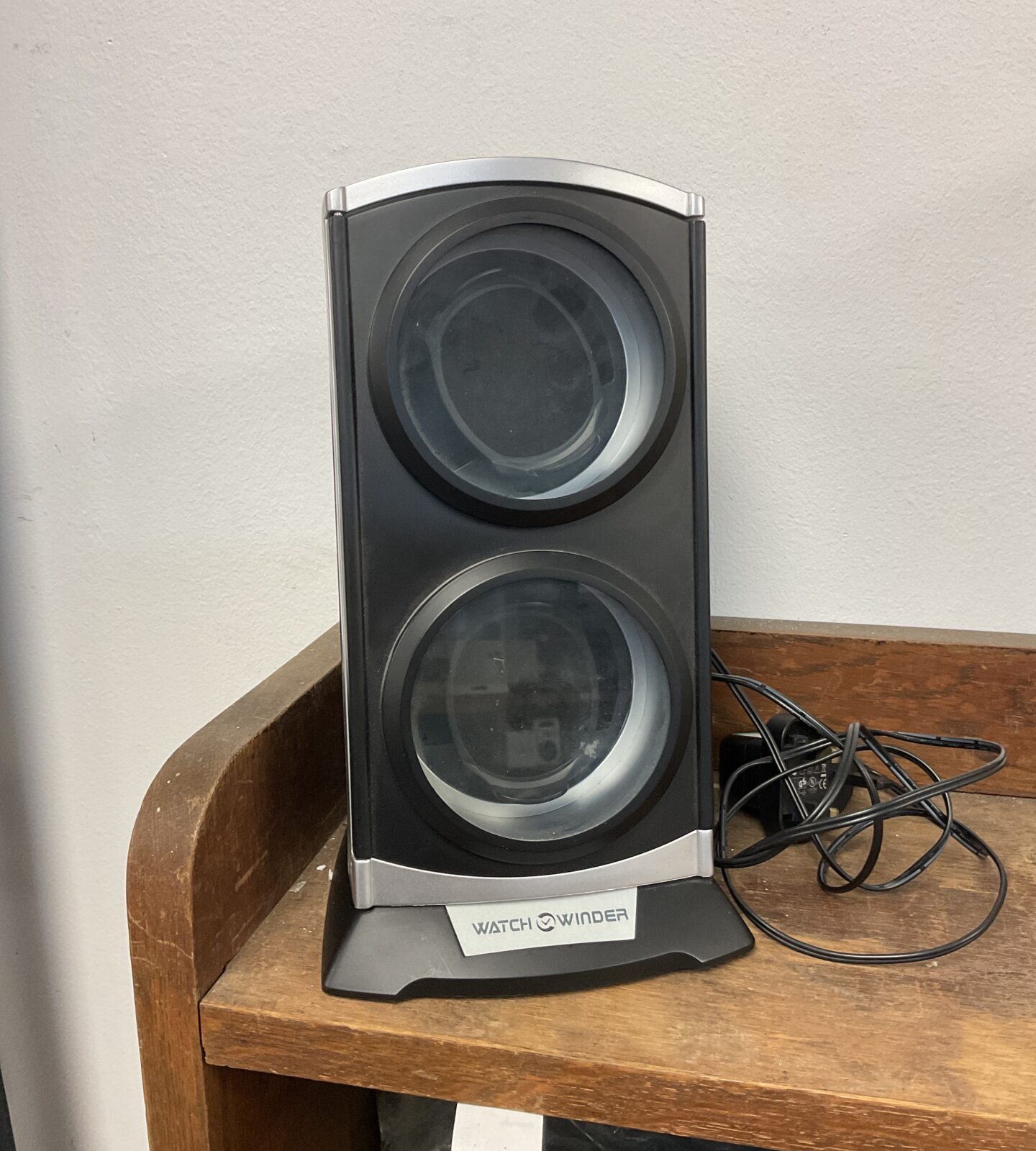 Black automatic watch winder for maintaining timepieces.