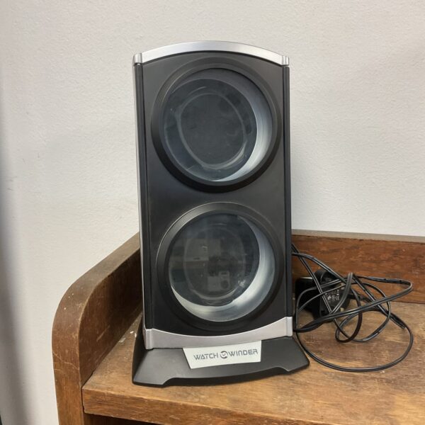 Black automatic watch winder for maintaining timepieces.