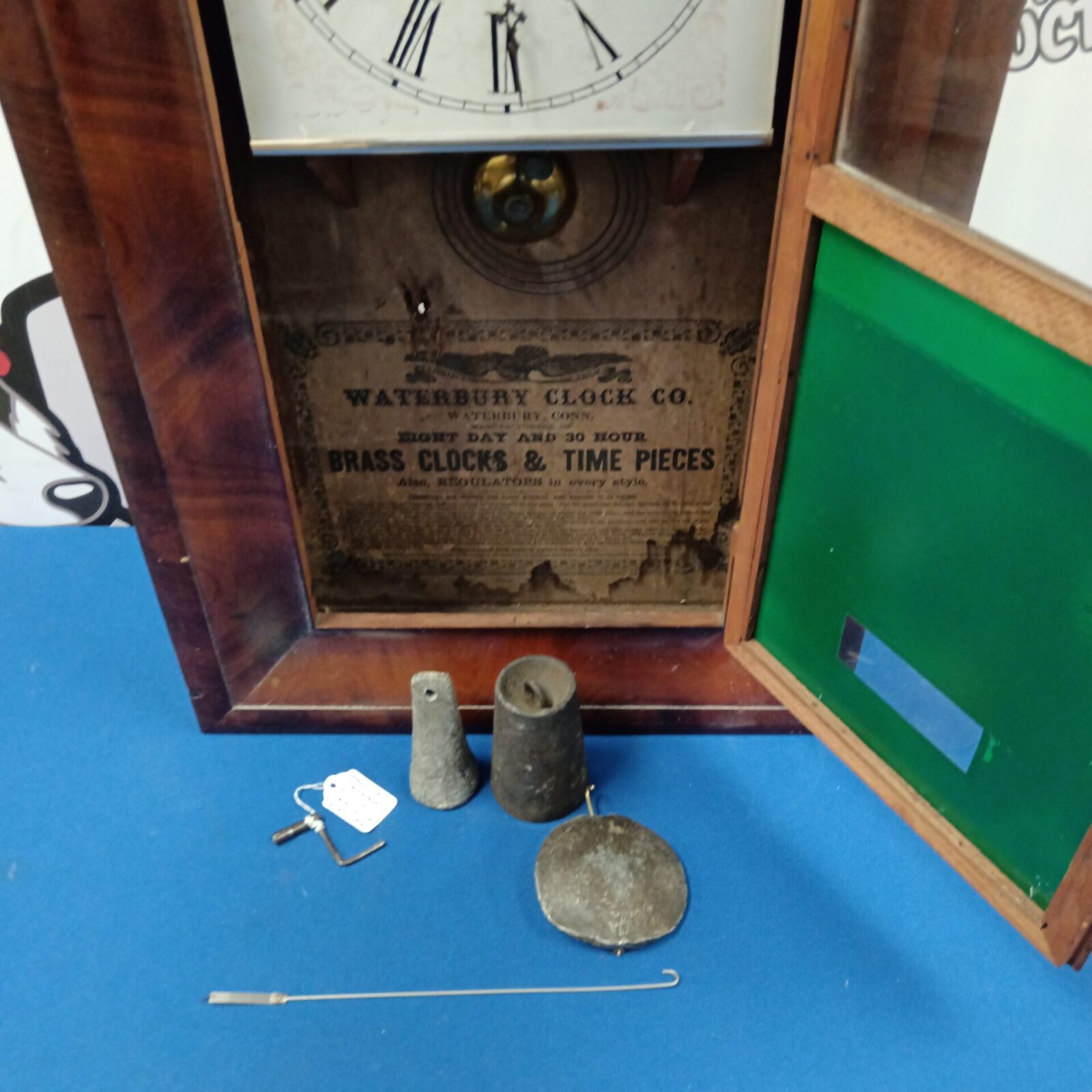 Clock parts including pendulum and weights for Waterbury clock.