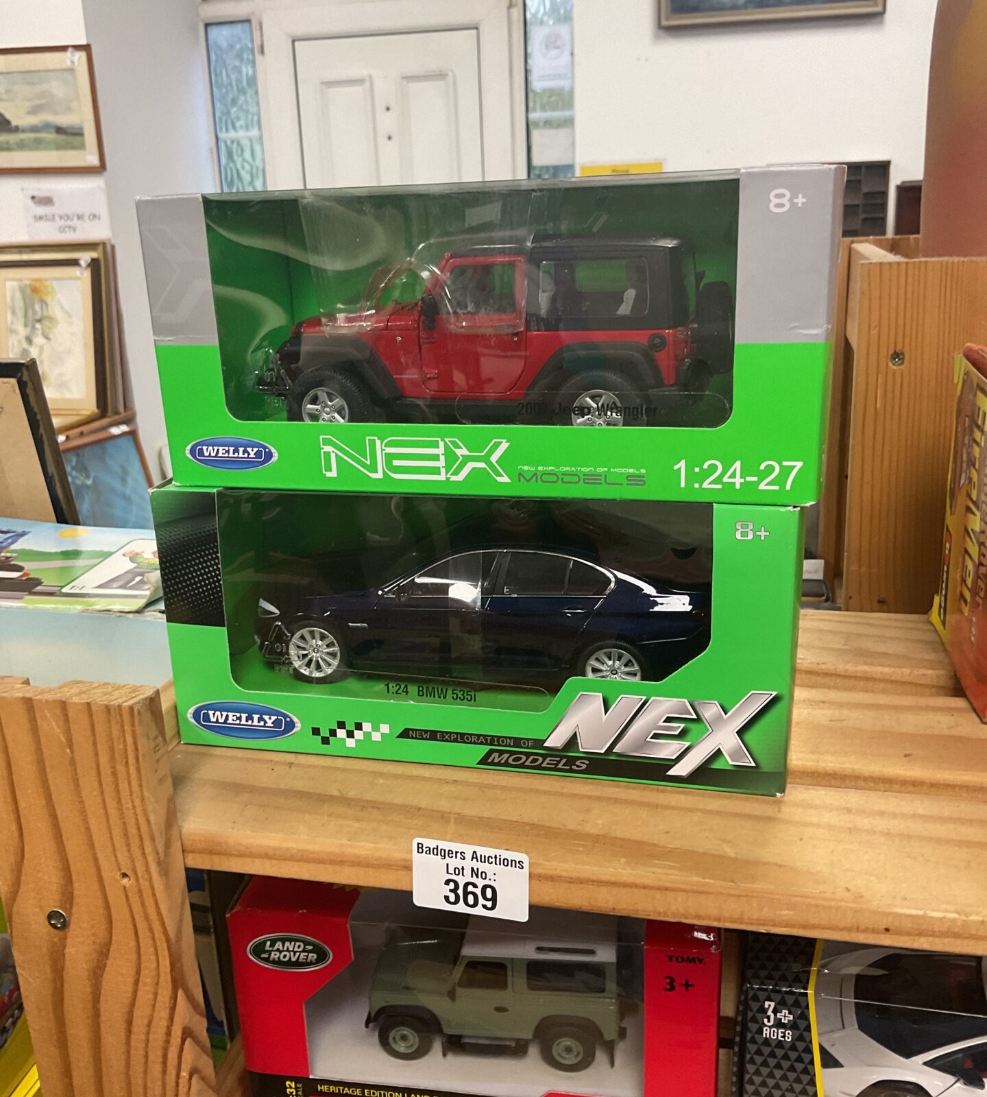 Two boxed Welly NEX diecast model cars in excellent condition.