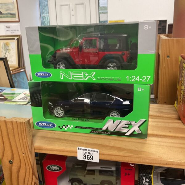 Two boxed Welly NEX diecast model cars in excellent condition.