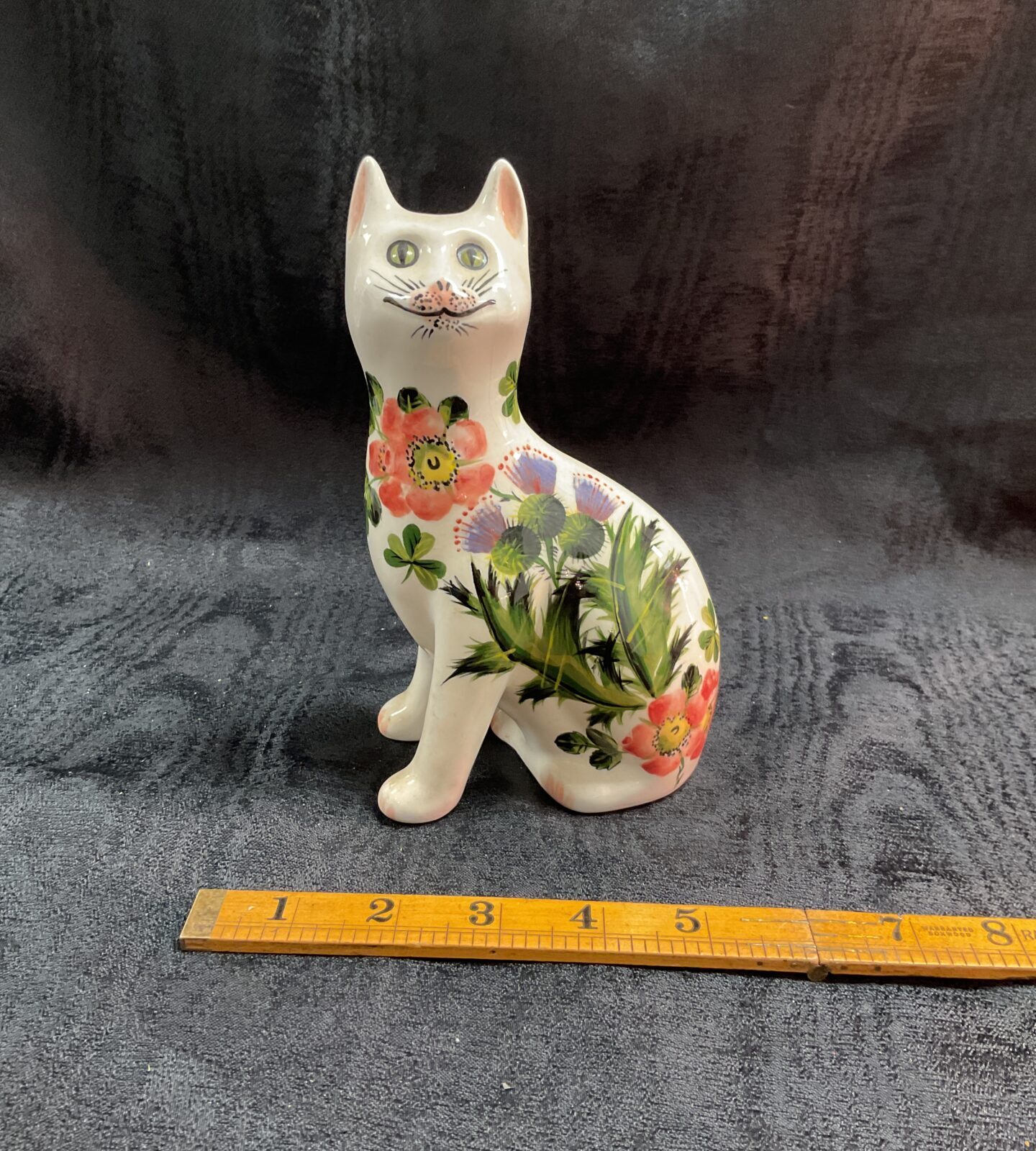 Hand-painted Wemyss Pottery cat by Griselda Hill with floral design.