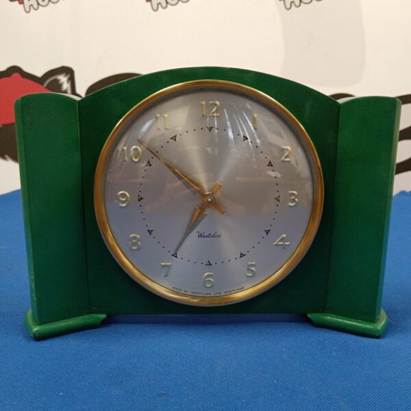 Vintage green Westclox Deco mantle clock on a dark surface.