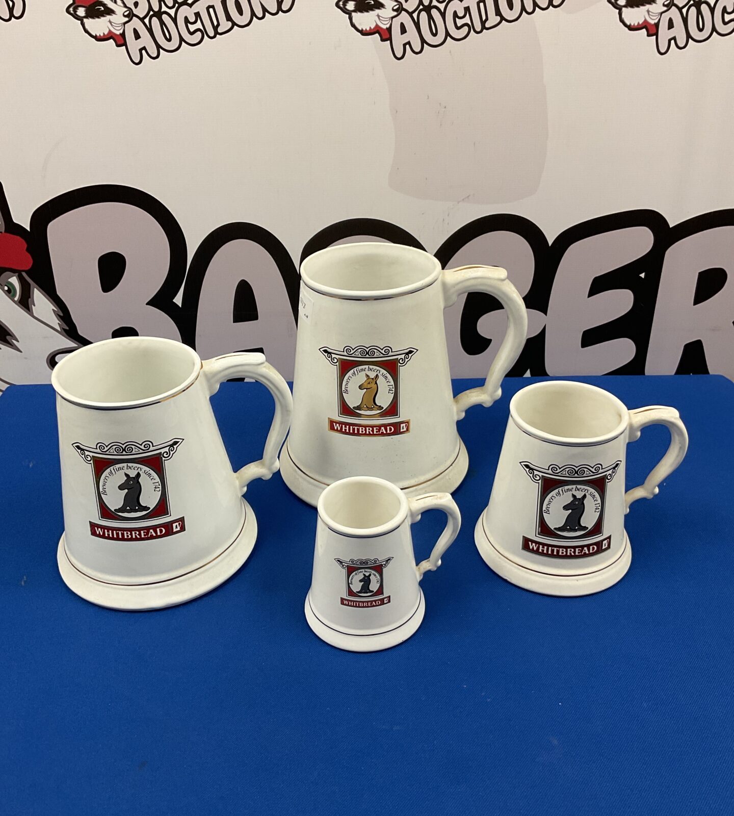 Set of four vintage Whitbread Brewery graduated tankards.