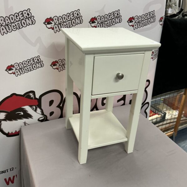 White bedside cabinet with a single drawer, ideal for bedroom storage.