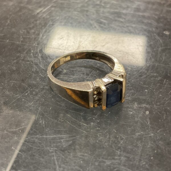 Elegant white gold ring with sapphire and diamond accents.