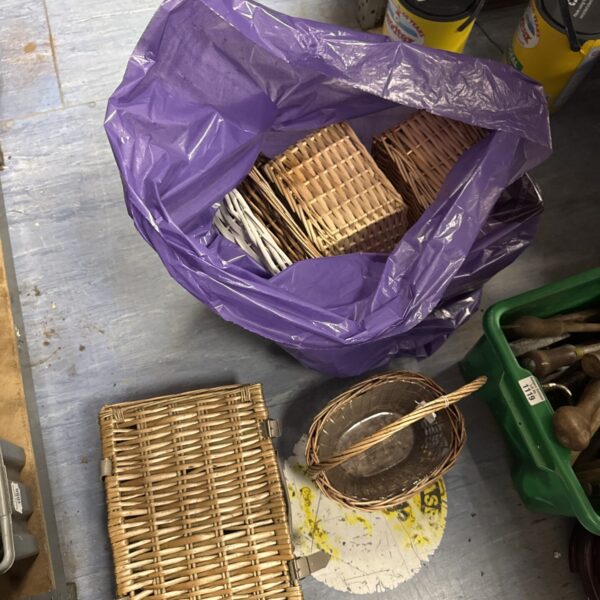 Purple bag filled with a variety of wicker baskets and trays.