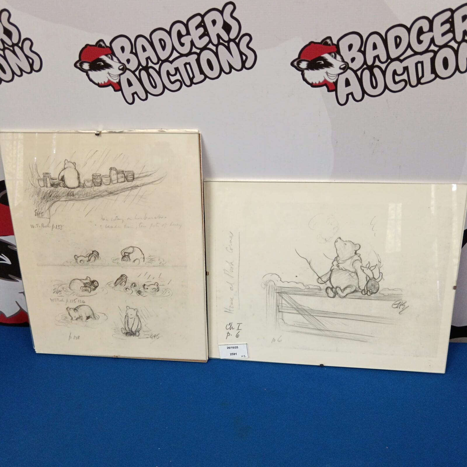 Two framed Winnie the Pooh prints with classic Disney illustrations.