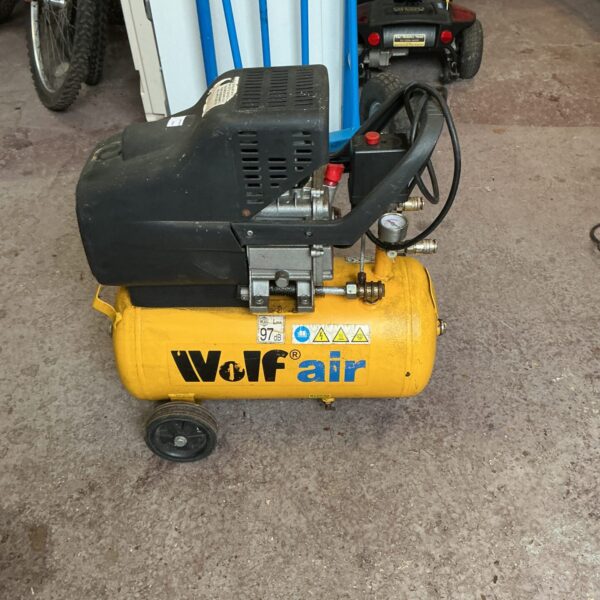 Portable Wolf air compressor with hose and gauge.