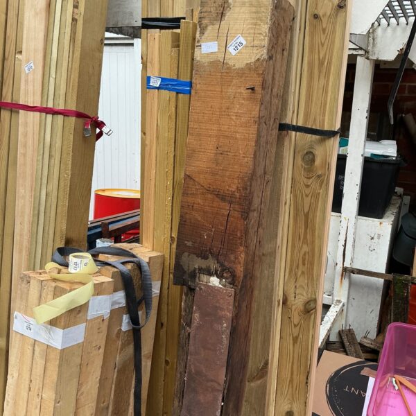 Rustic wood beam with metal plate for construction or decor.