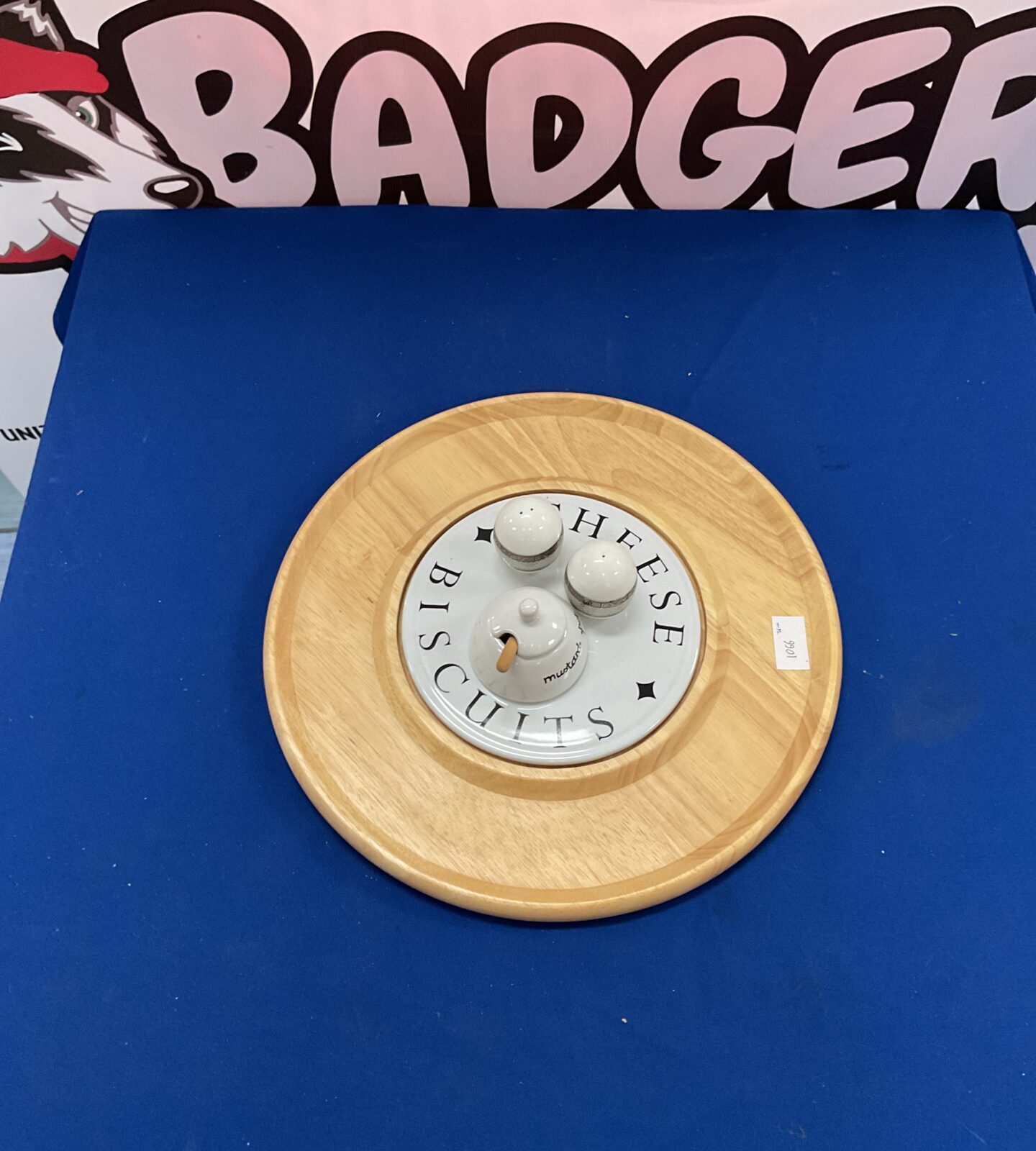 Circular wooden cheese and biscuit board for serving appetizers.
