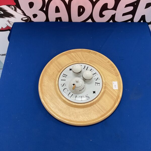 Circular wooden cheese and biscuit board for serving appetizers.