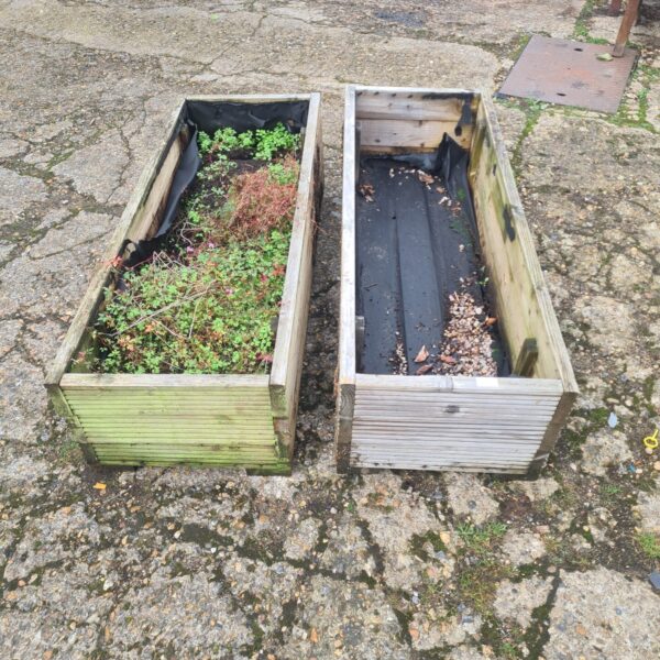 Two large wooden garden troughs lined with plastic.