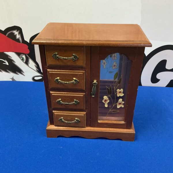 Vintage wooden jewellery box with multiple small drawers for storage.