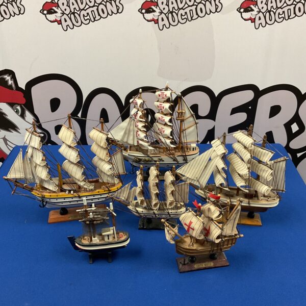 Detailed wooden model sailboats including Santa Maria, Sagres, and Terre Adelie.