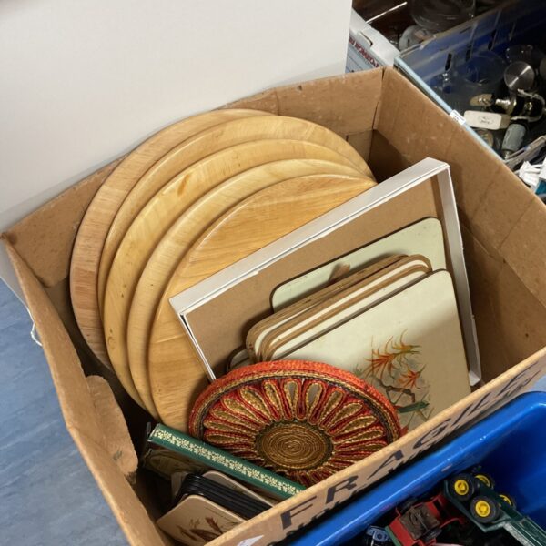 Wooden place mats and coasters in a box, rustic kitchen decor.