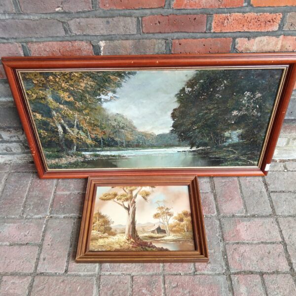 Pair of vintage woodland oil paintings with forest scenes.