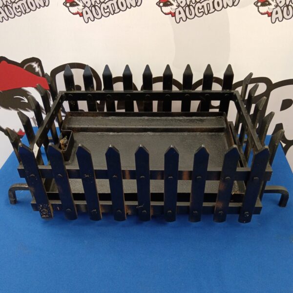 Vintage wrought iron fireplace basket with ornate detailing.